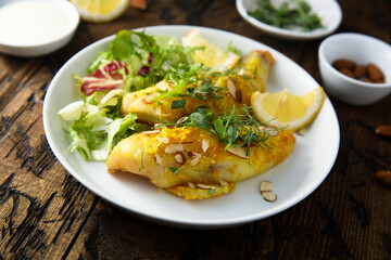 Roasted fish with almond flakes