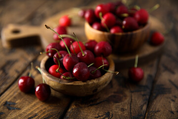 Fresh ripe cherries in a wooden bowl