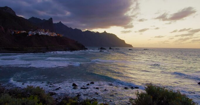 Beautiful golden sunset, north Tenerife, Atlantic Ocean, Almaciga black sandy beach. Twilight.