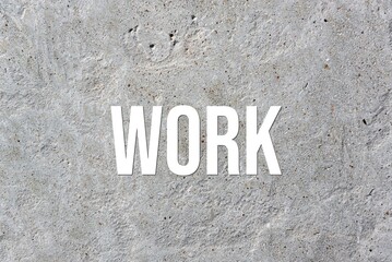 WORK - word on concrete background. Cement floor, wall.