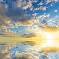 Obraz premium Sky blue and orange light of the sun through the clouds in the sky