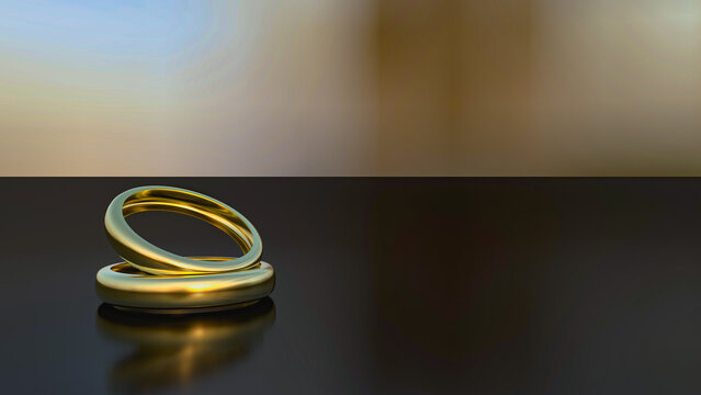 Close up of two wedding rings on top of a black table