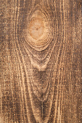 Background is burnt pine board close up with pronounced wood texture.