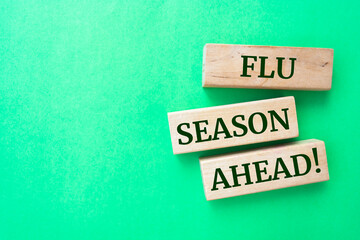 FLU SEASON AHEAD text on wooden block.