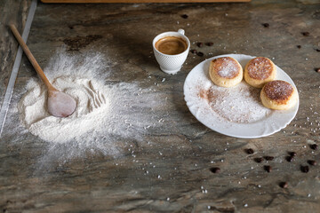 Fresh cheesecake with a cup of coffee on the table in the kitchen