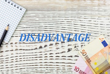 Naklejka premium DISADVANTAGE - word (text) and euro money on a white wooden table, notebook, notepad. Business concept: buying, selling, commerce (copy space).