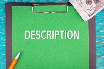 DESCRIPTION - word (text) and money a pack of dollar bills on a green background notepad, pen....