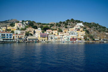 Naklejka na ściany i meble Boat Symi greek island coast mediterranean village