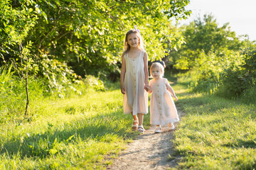 two girls are walking in the park