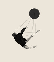 Contemporary art collage with young woman, ballerina attached to strings and falling down isolated on grey background. Line art design