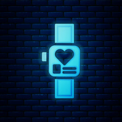Glowing neon Smart watch showing heart beat rate icon isolated on brick wall background. Fitness App concept. Vector
