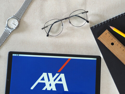 In this photo illustration AXA Group logo seen displayed on a tablet