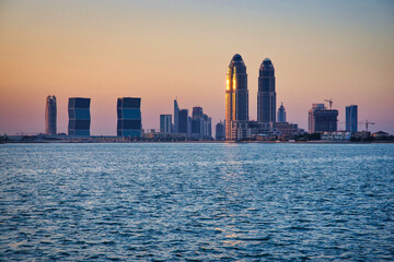 Fototapeta premium Doha city skyline from the water at sunset