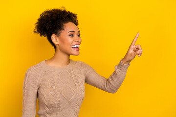 Photo of impressed millennial brunette lady point promo wear beige sweater isolated on yellow color background
