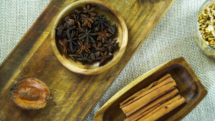 condiments and spices hot peppers saffron cloves and nuts. rustic farmhouse style mortar. ingredients for cooking.