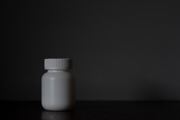 White plastic pill bottle and blank space for text.