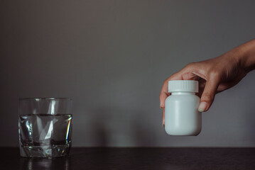 White plastic pill bottle and blank space for text.
