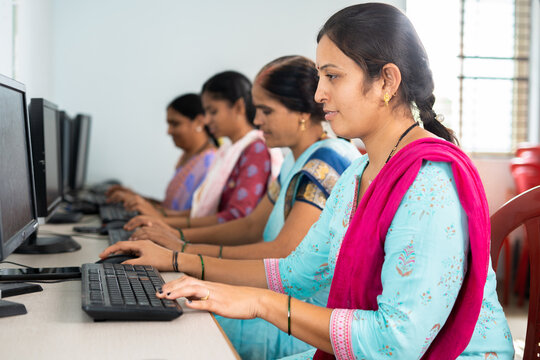 group of women busy learning or working on computer at training center - concept of empowerment, learning and education