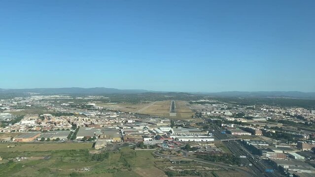 Stunning pilot point of view during landig maneuver in a summer windy day to Valencia&rsquo;s airport. Spain.