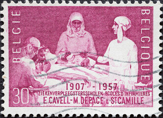BELGIUM - CIRCA 1957: a postage stamp from BELGIUM, showing a medical operation at a nursing school. Circa 1957