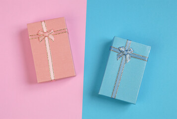 A blue and pink gift box placed against a backdrop of opposite colors.