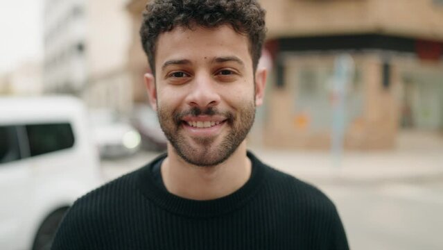 Young arab man smiling confident standing at street