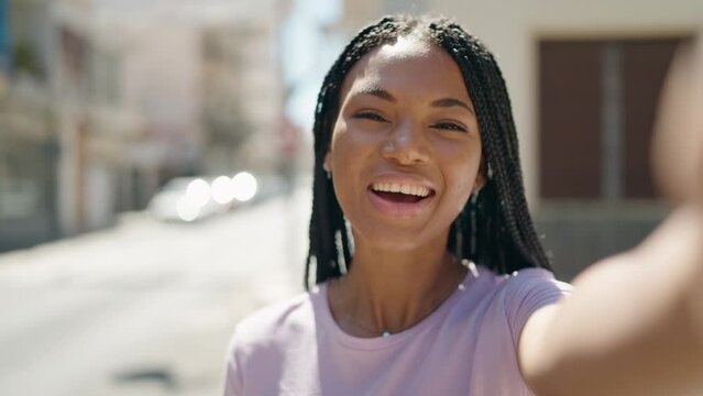 African american woman smiling confident having video call at street