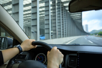 Fototapeta premium People driving car on city road