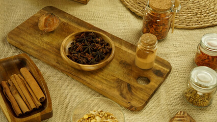 condiments and spices hot peppers saffron cloves and nuts. rustic farmhouse style mortar. ingredients for cooking.