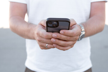 Close up of a man using mobile smart phone