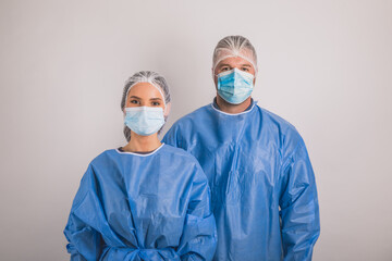 Fototapeta na wymiar doctors man and woman on a white background in medical masks on the face