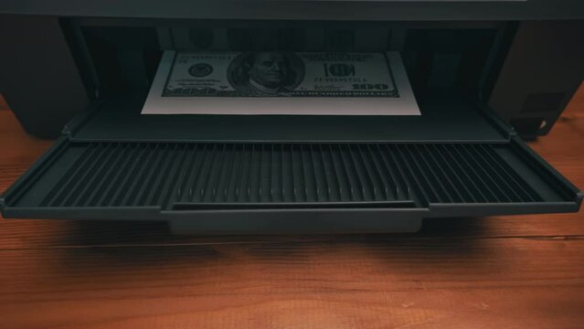 Print on a counterfeit one hundred dollar bill. Fake money, illegal actions. Illegal printing of money. American dollars print on A4 sheet.