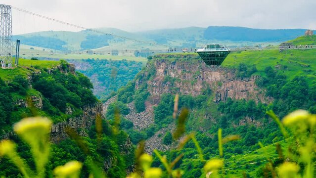 DAshbash, Georgia - 15th june, 2022: tourist walk on new glass bridge over DAshbashi canyon in Georgia time-lapse. Famous travel destination