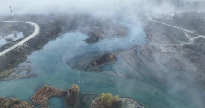 Misty early winter monring al lake where water evaporates creating amazing fog