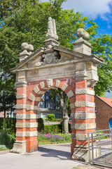 Fototapeta na wymiar Historic red brick gate in the harbor of Emden, Germany