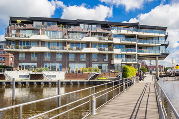 Wooden bridge and modern apartment building in Emden, Germany