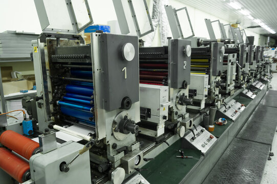 Used modern multi-color roll printing machine for the production of self-adhesive labels. Equipment for printing house. Selective focus