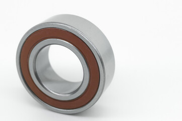 Closed type bearing for modern equipment and machines on a white background. Ball bearing with protective covers. Selective focus