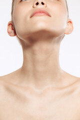 Obraz na płótnie Canvas Close up female neck, collarbones isolated on white studio background. Natural beauty, fitness, diet, spa, plastic surgery and aesthetic cosmetology