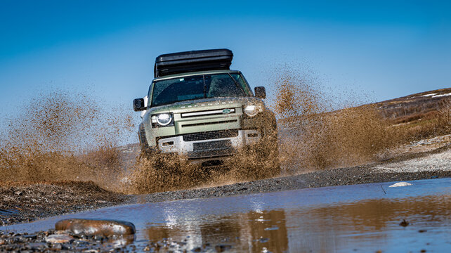 Rybachy, RUSSIA - May 30 2022: Off-roading New Land Rover Defender. The Land Rover Defender is a series of British off-road cars and pick-up trucks.