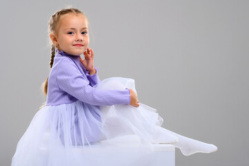 Emotional little girl in the studio on a white background. Portrait