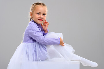 Emotional little girl in the studio on a white background. Portrait