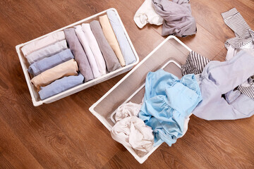 Baskets with neat piles of laundry and a scattered pile of clothes. The concept of cluttering,...
