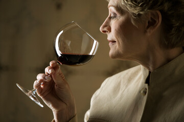 Woman smelling glass of red wine