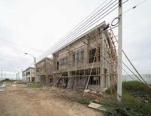 Under construction home or house with scaffolding on site in village. Interior. Old unfurnished room rental property, living space units. lifestyle. Renovation.