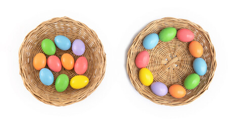 Colorful easter eggs on a basket and white background. Food decoration on holiday.