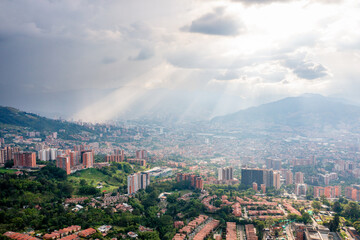 Fototapeta premium Rays of sun shining on the Colombian City of Medellin