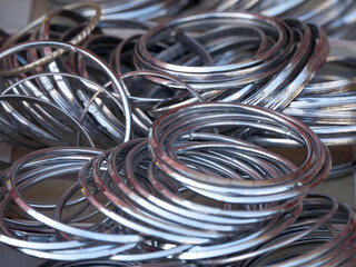 Display of metal bangles for wearing in hand by women, female, girls in India.