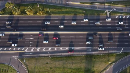down tilt drone shot of the busy general paz highway at sunset in buenos aires in argentina