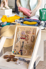 Young women at swap home party - clothes, shoes, bags, jewellery exchange between friends. Zero waste shopping, eco friendly concept, sustainable lifestyle. College life. 